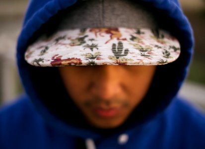 close up photo of white, green, and red floral cap photo