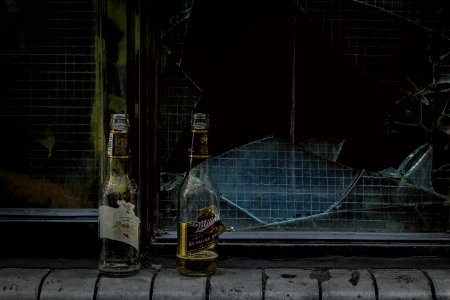 two wine bottles near door