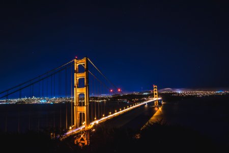 lighted bridge during nighttime photo