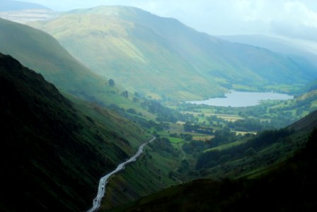 river at middle of mountains near forests photo