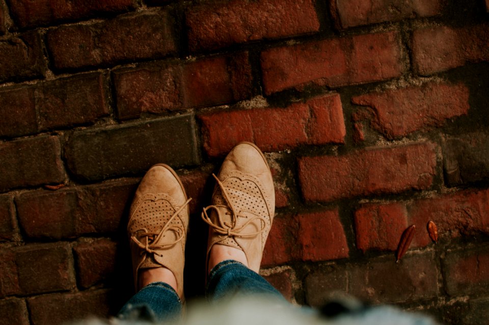 person standing on brick pavement