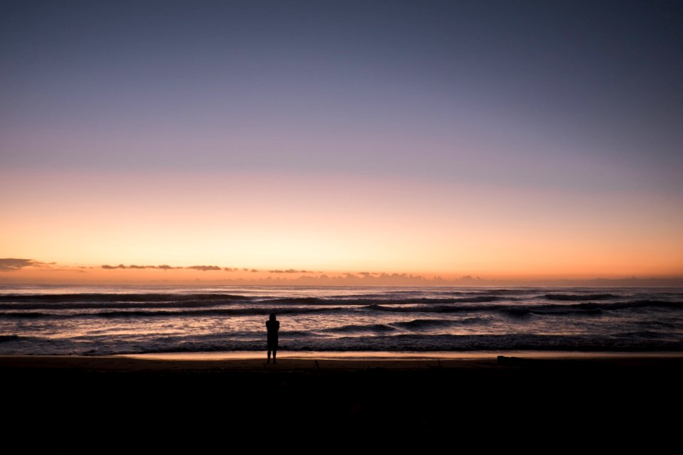 person in the beach during sunset