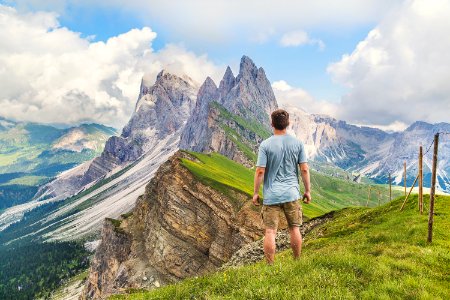 man in blue T-shirt on top of the mountain under the blue sky photo