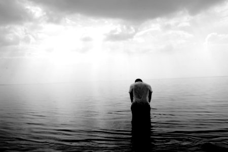 grayscale photography of person on beach