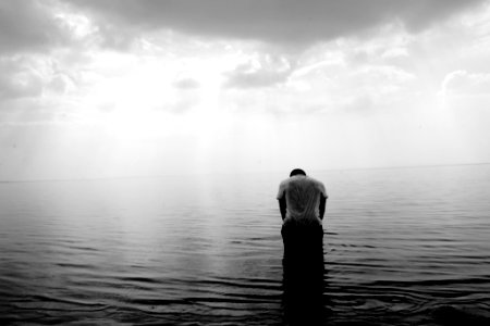 grayscale photography of person on beach photo