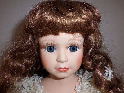 Girl faces dolls head