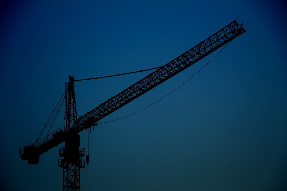 black metal crane tower under blue sky