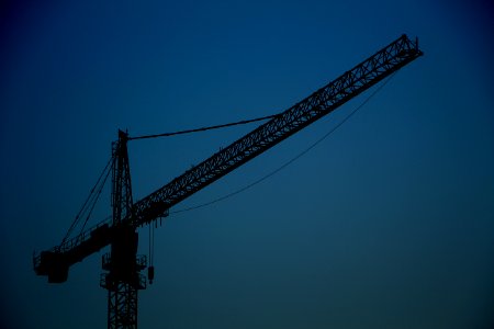 black metal crane tower under blue sky