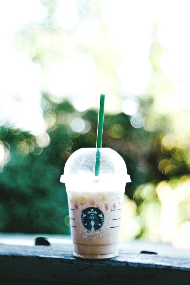 Starbucks smoothie on gray bench bokeh photography