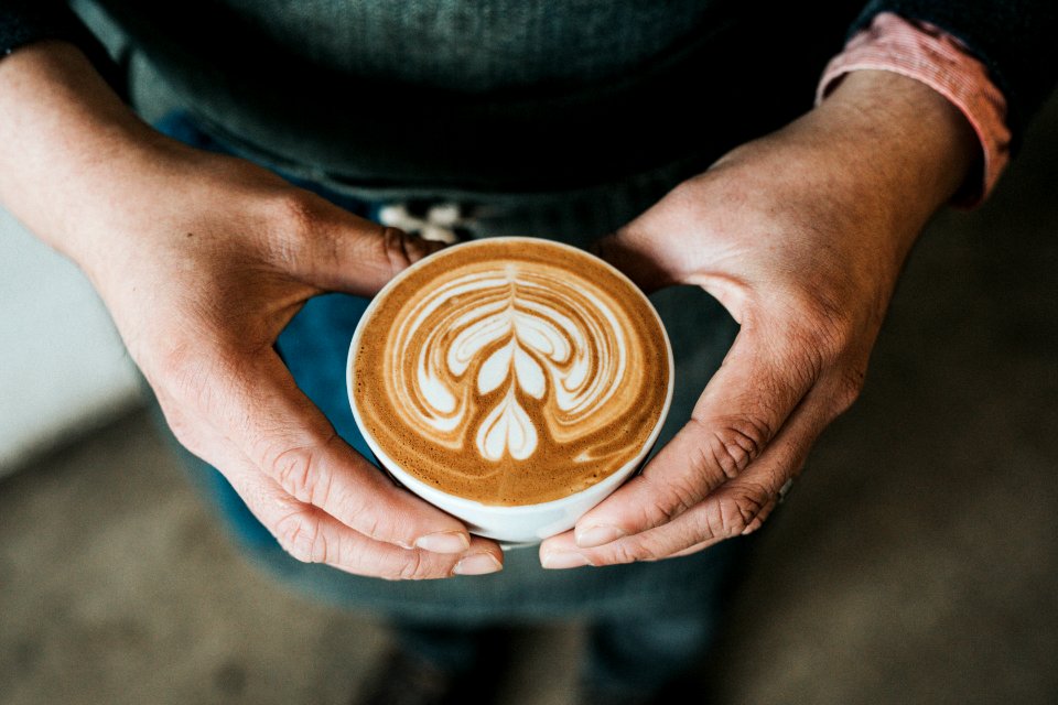 focus photography of coffee artwork