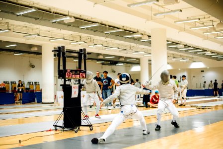 two person wearing white suit doing fencing photo