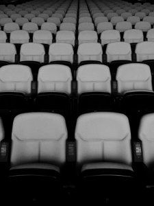 vacant white and black theater chairs with no people photo