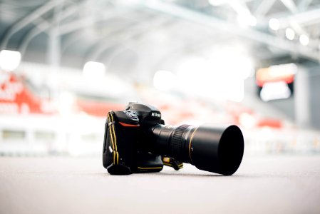 selective focus photography of Nikon DSLR camera on ground photo