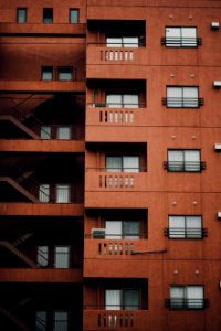 brown concrete building with stairs on the side photo