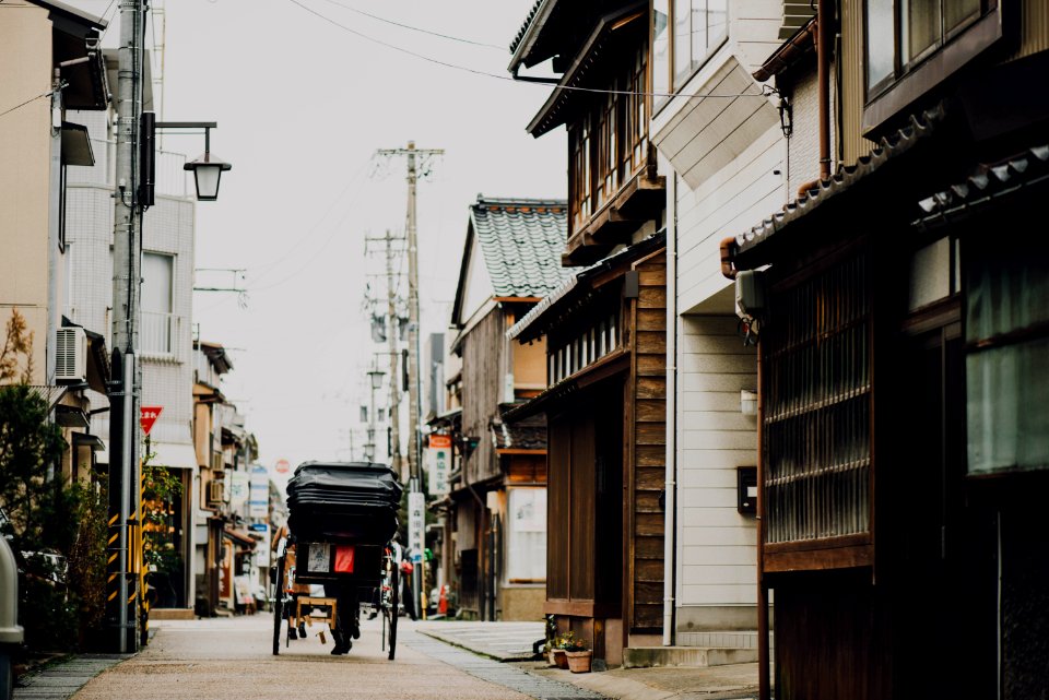 black carriage passing through buildings photo