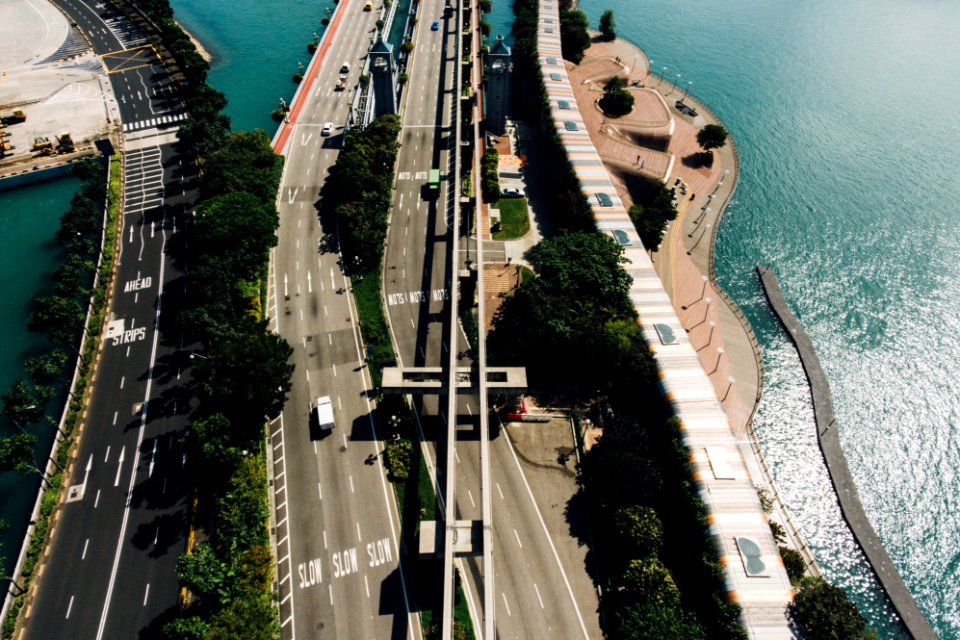 vehicles on road near body of water