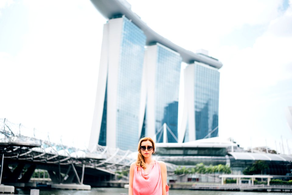 woman standing in front of gray concrete structure
