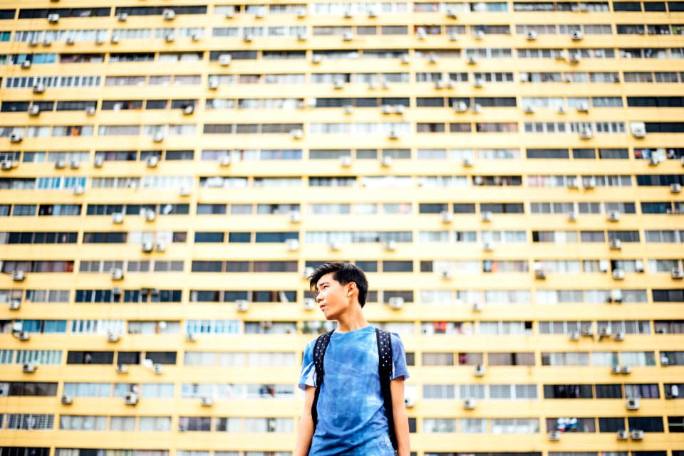 man standing in front of skyscraper photo