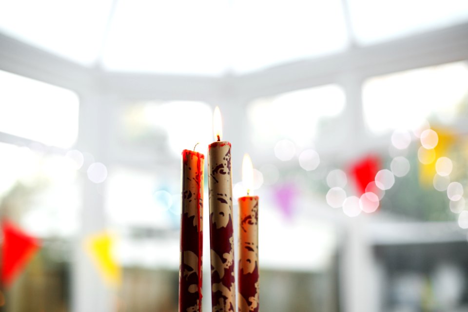 three brown-and-red candles on top of table