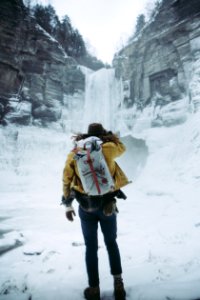 woman facing frozen waterfalls photo