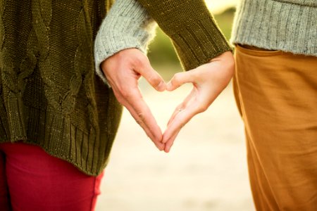 person forming heart shape with their hands photo