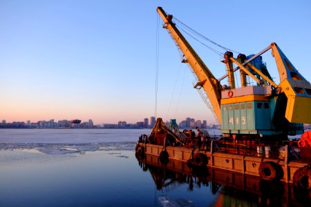 yellow and blue commercial machine near body of water