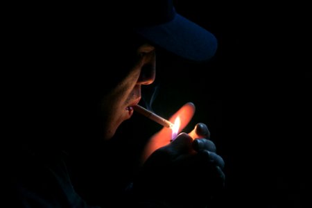man lighting his cigarette photo