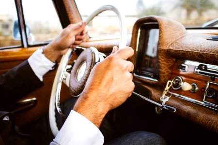 person holding vehicle steering wheel photo