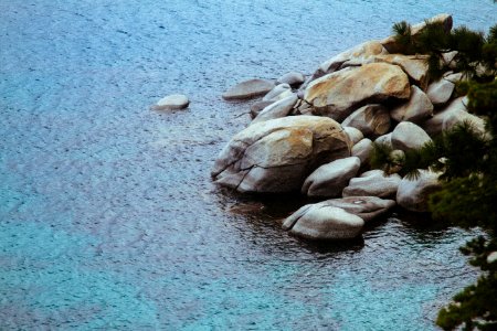 high angle photography of pile of stone beside body of water photo