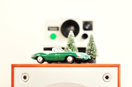 selective focus photography of green coupe die-cast model