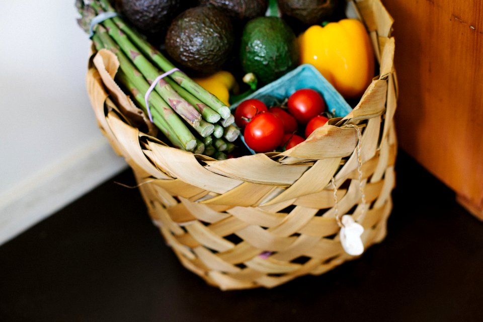 bunch of assorted produce in brown wicker basket