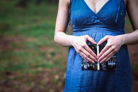 pregnant woman holding her tummy photo