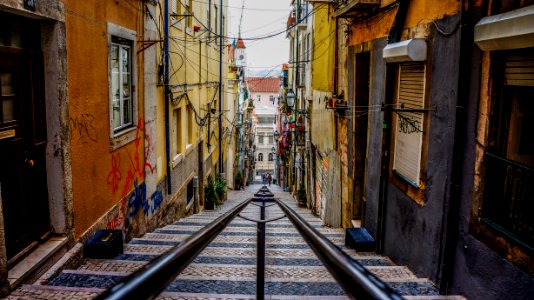 stairs in between colorful buildings