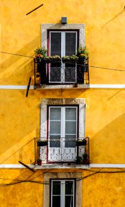 white wooden window panels and yellow painted wall