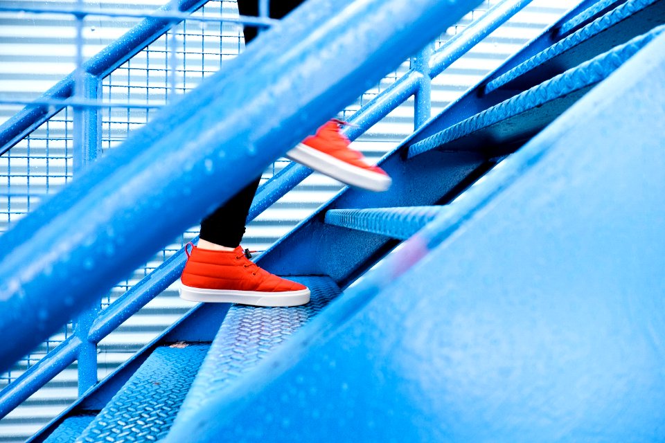 person stepping on blue stairs