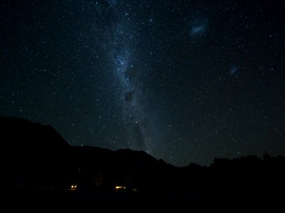 mountains and sky full of stars during night