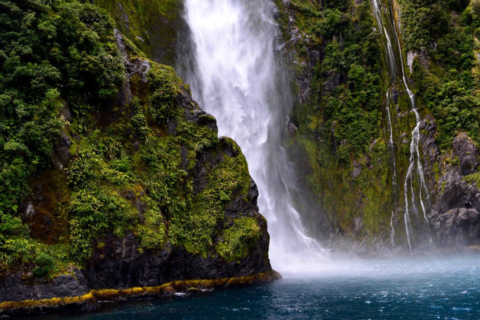 waterfall streaming through lake