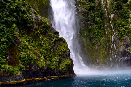 waterfall streaming through lake