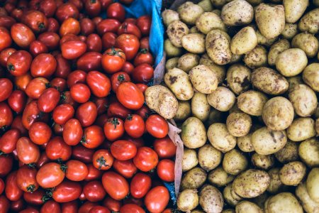 photography of orange tomatoes and brown potatoes