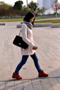 woman walking while holding smartphone