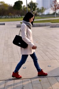 woman walking while holding smartphone photo