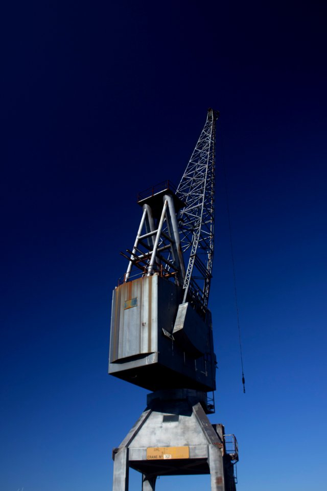 gray metal crane equipment under blue sky