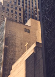 low angle photography of concrete building with cross photo