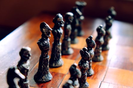 chess pieces on wooden chess board photo