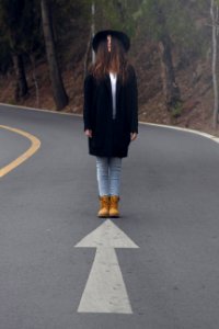 woman standing on asphalt road photo