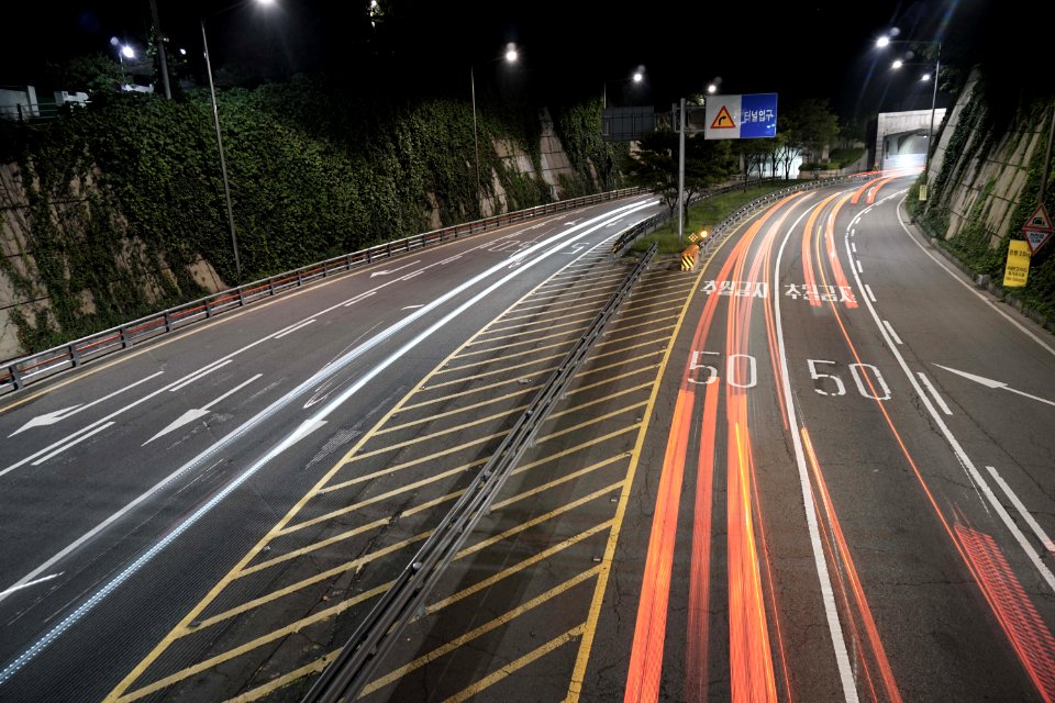 concrete road with street lights during nighttime