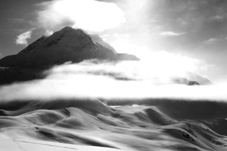 grayscale photo of mountain covered by fogs