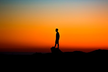 silhouette of man during sunset photo
