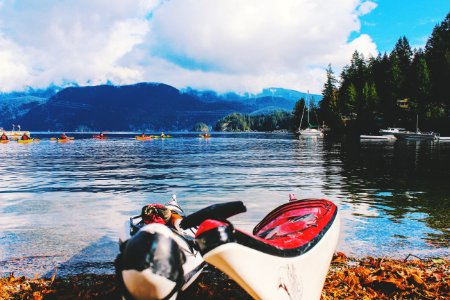 two white kayaks along body of water