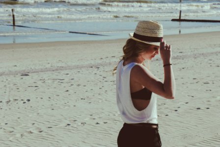 woman standing on beach sand photo